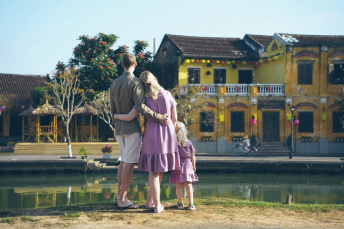 Family looking at colorful buildings by the water